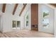 Open-concept living room with vaulted ceilings, wooden beams, modern fireplace, and bright natural lighting at 859 N Bay Overlook, Villa Rica, GA 30180