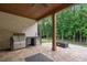 Covered outdoor kitchen with grill, sink, and stainless-steel appliances at 859 N Bay Overlook, Villa Rica, GA 30180