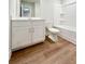 Bathroom featuring a white vanity with solid surface counters, a toilet and tub with shower at 2407 Malster Ln, Lawrenceville, GA 30043