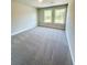 Comfortable bedroom with neutral carpet and two windows providing natural light at 2407 Malster Ln, Lawrenceville, GA 30043