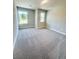 Cozy bedroom with neutral carpeting and two windows, providing ample natural light at 2407 Malster Ln, Lawrenceville, GA 30043