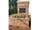 Brick community sign for West Herrington Heights with flowers at 2407 Malster Ln, Lawrenceville, GA 30043