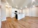 Bright kitchen with a large island, white cabinets, and stainless steel appliances opening to living area at 2407 Malster Ln, Lawrenceville, GA 30043