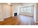Spacious living room featuring hardwood floors, a fireplace, and large windows offering ample natural light at 2407 Malster Ln, Lawrenceville, GA 30043