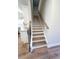Elegant staircase with wood treads, white risers, and a stylish handrail, leading to the upper level at 2407 Malster Ln, Lawrenceville, GA 30043