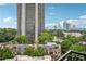 Expansive view showcases a high-rise residential building surrounded by lush green trees at 2626 Peachtree Nw Rd # 1108, Atlanta, GA 30305