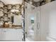 Featuring a walk-in shower, this bathroom features granite counters and designer wallpaper at 2626 Peachtree Nw Rd # 1108, Atlanta, GA 30305