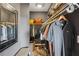 Organized walk-in closet featuring shelving, hanging space, mirror and a bench for accessible storage at 2626 Peachtree Nw Rd # 1108, Atlanta, GA 30305