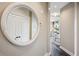 Hallway with round mirror leading to a bright living space at 2626 Peachtree Nw Rd # 1108, Atlanta, GA 30305