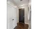 Hallway with hardwood floors, white doors, and a decorative mirror creating a welcoming entrance at 2626 Peachtree Nw Rd # 1108, Atlanta, GA 30305
