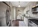 Modern kitchen with stainless steel appliances and light wood cabinetry at 2626 Peachtree Nw Rd # 1108, Atlanta, GA 30305