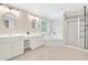 Luxurious bathroom featuring double vanities, soaking tub, walk-in shower with white tile and fixtures at 3260 Caney Creek Ln, Cumming, GA 30041