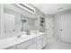 Spacious bathroom featuring double sinks, white cabinets, and neutral tile flooring at 3260 Caney Creek Ln, Cumming, GA 30041