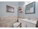 Bathroom with decorative tile accent wall, vanity, and a stylish mirror at 3260 Caney Creek Ln, Cumming, GA 30041