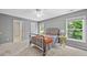 Neutral bedroom featuring a metal bed frame, side table, and ample natural light at 3260 Caney Creek Ln, Cumming, GA 30041