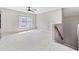 Spacious bonus room with natural light, neutral paint, and stairs to the second floor at 3260 Caney Creek Ln, Cumming, GA 30041