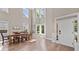Elegant dining area with high ceilings, abundant natural light, and hardwood floors at 3260 Caney Creek Ln, Cumming, GA 30041