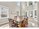 Bright dining space featuring high ceilings, a wooden table, and multiple windows at 3260 Caney Creek Ln, Cumming, GA 30041