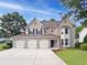 Charming two-story home featuring a three-car garage and well-maintained landscaping at 3260 Caney Creek Ln, Cumming, GA 30041