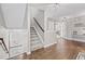 Inviting hallway features hardwood floors, gray walls, and a staircase leading to the upper level at 3260 Caney Creek Ln, Cumming, GA 30041