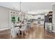 Kitchen with eat-in area featuring stainless appliances, granite countertops, and hardwood floors at 3260 Caney Creek Ln, Cumming, GA 30041
