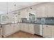 Well-equipped kitchen featuring white cabinets, stainless steel appliances, and sleek countertops at 3260 Caney Creek Ln, Cumming, GA 30041