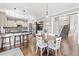 Kitchen with eat-in area featuring stainless appliances, granite countertops, and hardwood floors at 3260 Caney Creek Ln, Cumming, GA 30041
