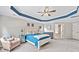 Bright and airy main bedroom featuring a tray ceiling, a ceiling fan, and multiple windows at 3260 Caney Creek Ln, Cumming, GA 30041