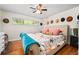 Bedroom features a decorative hat display above the bed and wood floors at 3317 Embry Hills Dr, Atlanta, GA 30341