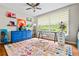 Office with a large window, bright blue dresser, and colorful area rug over hardwood floors at 3317 Embry Hills Dr, Atlanta, GA 30341