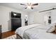 Bright bedroom featuring a ceiling fan, a dark wood dresser, and a door leading to the bathroom at 3317 Embry Hills Dr, Atlanta, GA 30341
