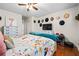 Bedroom features a decorative hat display above the bed and wood floors at 3317 Embry Hills Dr, Atlanta, GA 30341