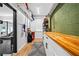 Hallway with butcher block countertops, white cabinets, storage shelves, and view of the gym at 3317 Embry Hills Dr, Atlanta, GA 30341