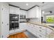 Kitchen features stainless steel appliances, granite countertops, and white cabinets at 3317 Embry Hills Dr, Atlanta, GA 30341