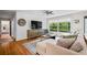Bright living room featuring a large window, modern furniture, and hardwood floors at 3317 Embry Hills Dr, Atlanta, GA 30341