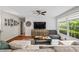 Bright living room with hardwood floors, white brick accent wall, and large windows at 3317 Embry Hills Dr, Atlanta, GA 30341