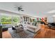 Spacious living room with a large sectional couch, stylish rug, and ample natural light at 3317 Embry Hills Dr, Atlanta, GA 30341