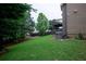 Lush backyard with healthy lawn and home exterior featuring a wood deck at 3758 Lake Haven Way, Atlanta, GA 30349