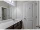 Bathroom with a vanity and cabinet, framed mirror, and a door to the shower and toilet at 3758 Lake Haven Way, Atlanta, GA 30349