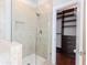 Bathroom showing large shower with glass surround and custom built-in storage in closet at 3758 Lake Haven Way, Atlanta, GA 30349