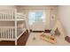 bedroom with bunk beds, a large window, and a play teepee at 3758 Lake Haven Way, Atlanta, GA 30349