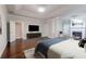 Bright and open primary bedroom boasting wood flooring, recessed lights, and a fireplace at 3758 Lake Haven Way, Atlanta, GA 30349