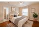 Bedroom boasts wood flooring, a ceiling fan, and decoratively placed wall art at 3758 Lake Haven Way, Atlanta, GA 30349