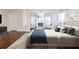 Bright bedroom features hardwood flooring, a neutral color palette, and a comfortable seating area at 3758 Lake Haven Way, Atlanta, GA 30349