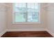 Walk-in closet with hardwood floors and a bright window overlooking the property at 3758 Lake Haven Way, Atlanta, GA 30349
