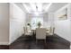 Elegant dining room with paneled walls, a modern light fixture, and seating for up to eight people at 3758 Lake Haven Way, Atlanta, GA 30349