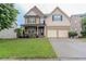 Charming two-story home with a combination of stone and siding, complemented by a well-kept green lawn at 3758 Lake Haven Way, Atlanta, GA 30349