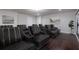 Home theater with tiered seating, dark hardwood floors, and large viewing screen at 3758 Lake Haven Way, Atlanta, GA 30349