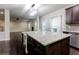 Open kitchen design featuring a large island, stainless steel appliances, and hardwood floors, connecting to the living area at 3758 Lake Haven Way, Atlanta, GA 30349