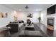 Open-concept living room with a fireplace, elegant furnishings, hardwood floors, and large windows at 3758 Lake Haven Way, Atlanta, GA 30349